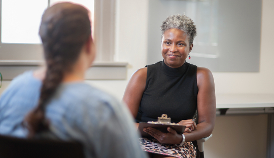 Woman talking to prospective student