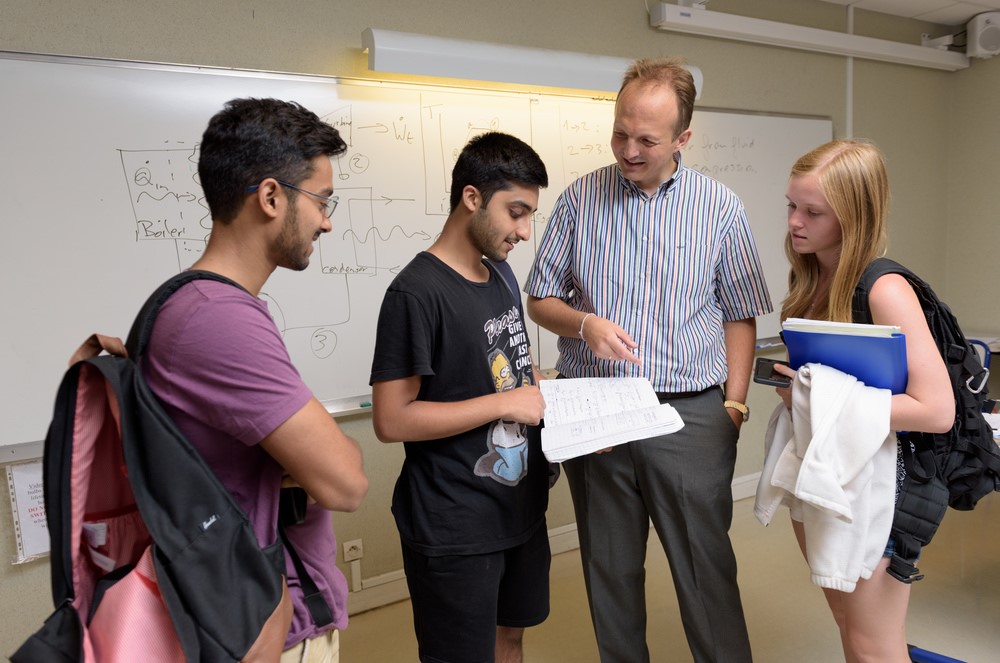 Undergraduate students talking with professor