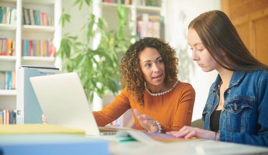 Student and advisor sitting at table