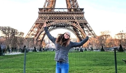 Woman jumping in front of eiffel tower