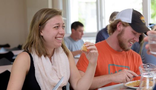 Students eating lunch and smiling