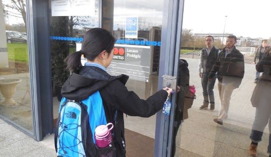 Student walking into building