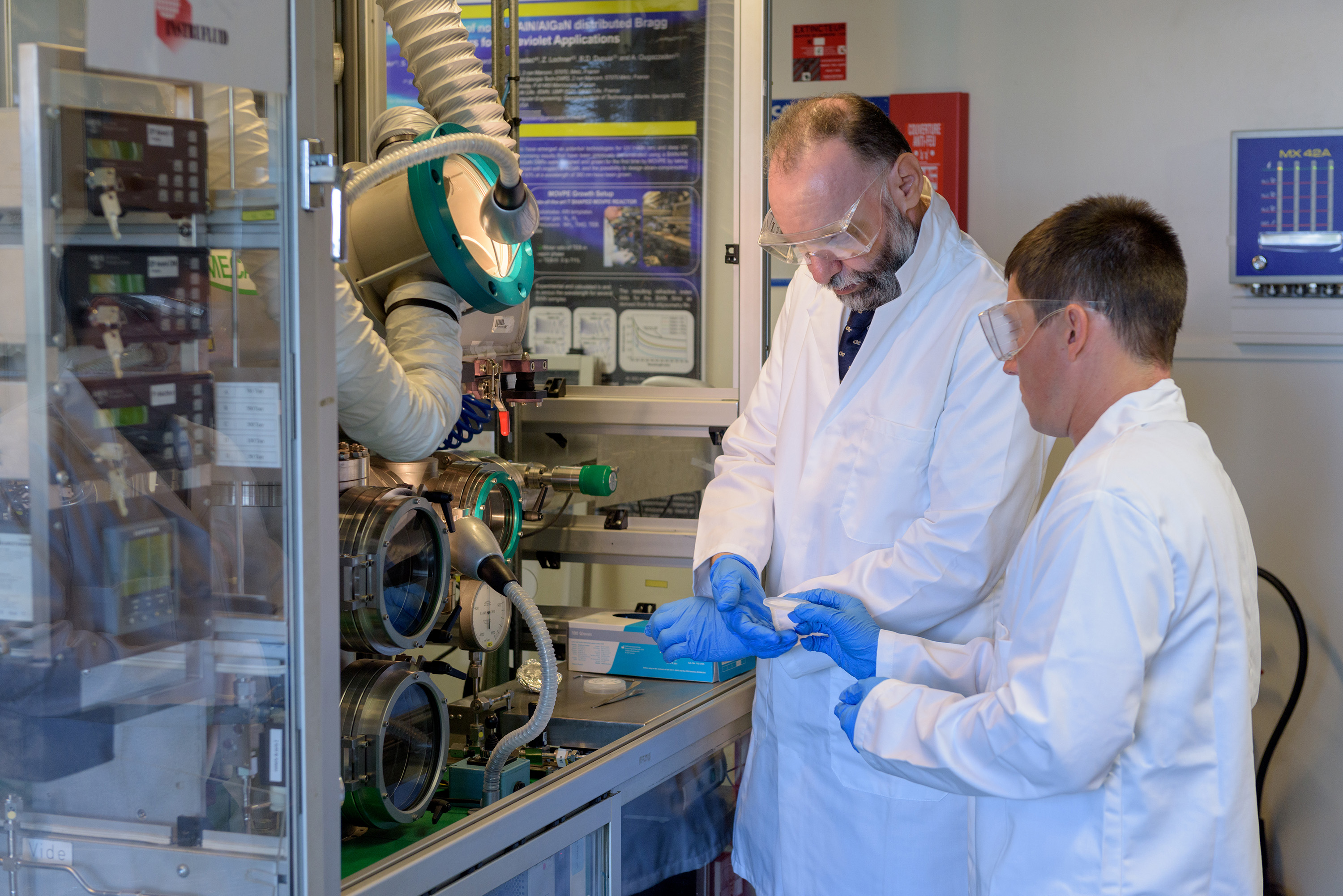 Abdallah Ougazzaden, director of Georgia Tech Lorraine in Metz, France and Chris Bishop, a researcher at Institut Lafayette, example a sample being processed in a lab at Georgia Tech Lorraine. (Credit: Rob Felt, Georgia Tech).